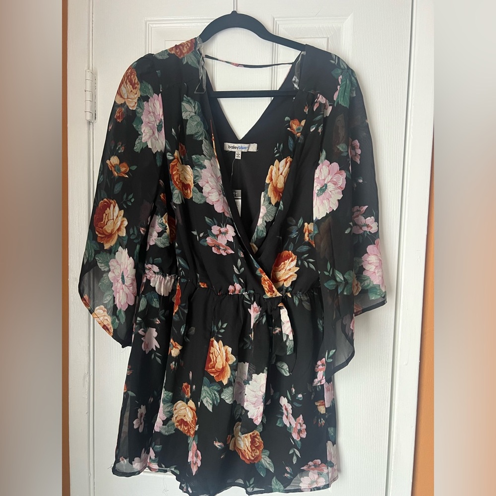 Cute flower print romper.  Never worn because it was too small.